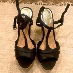 Black strappy wedge shoes.